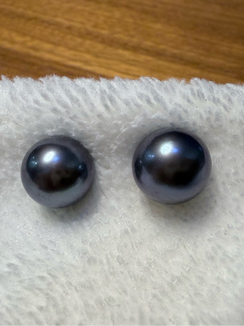 Vintage 10mm Black Pearl Stud Earrings, with a gold post and signed.